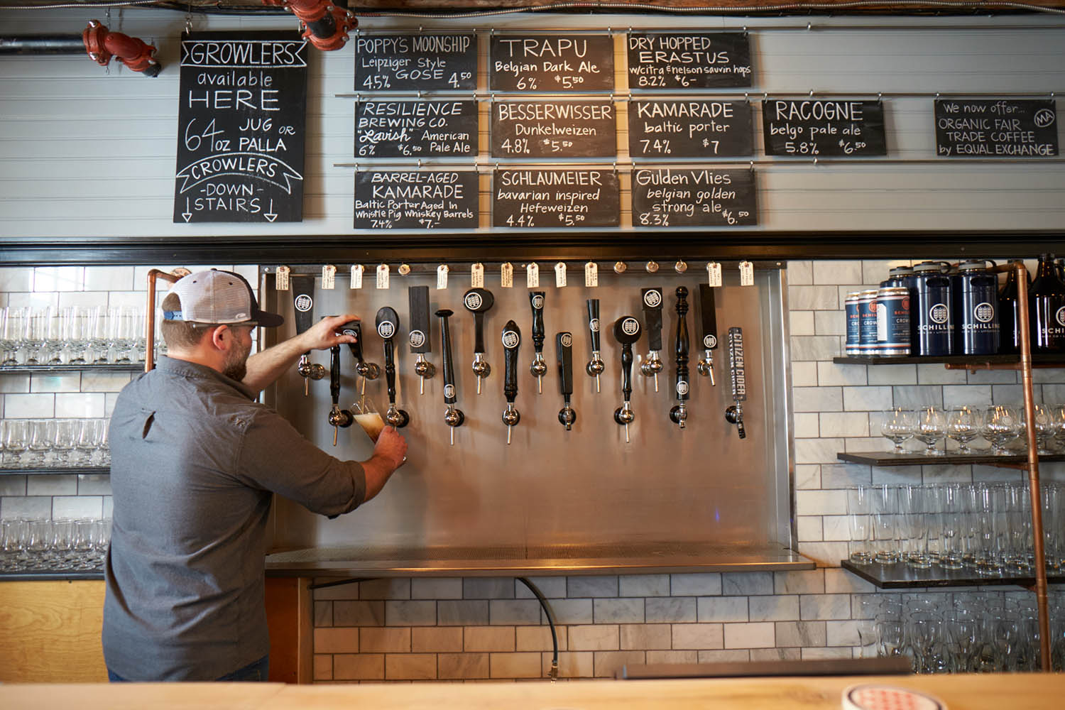 man getting beer from a tap