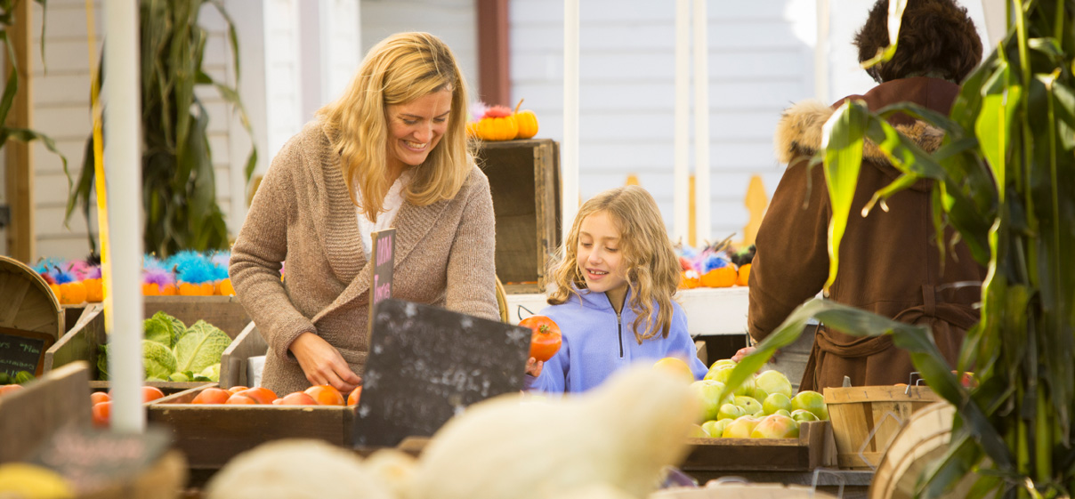 Mom and daughter shopping at a farmers market