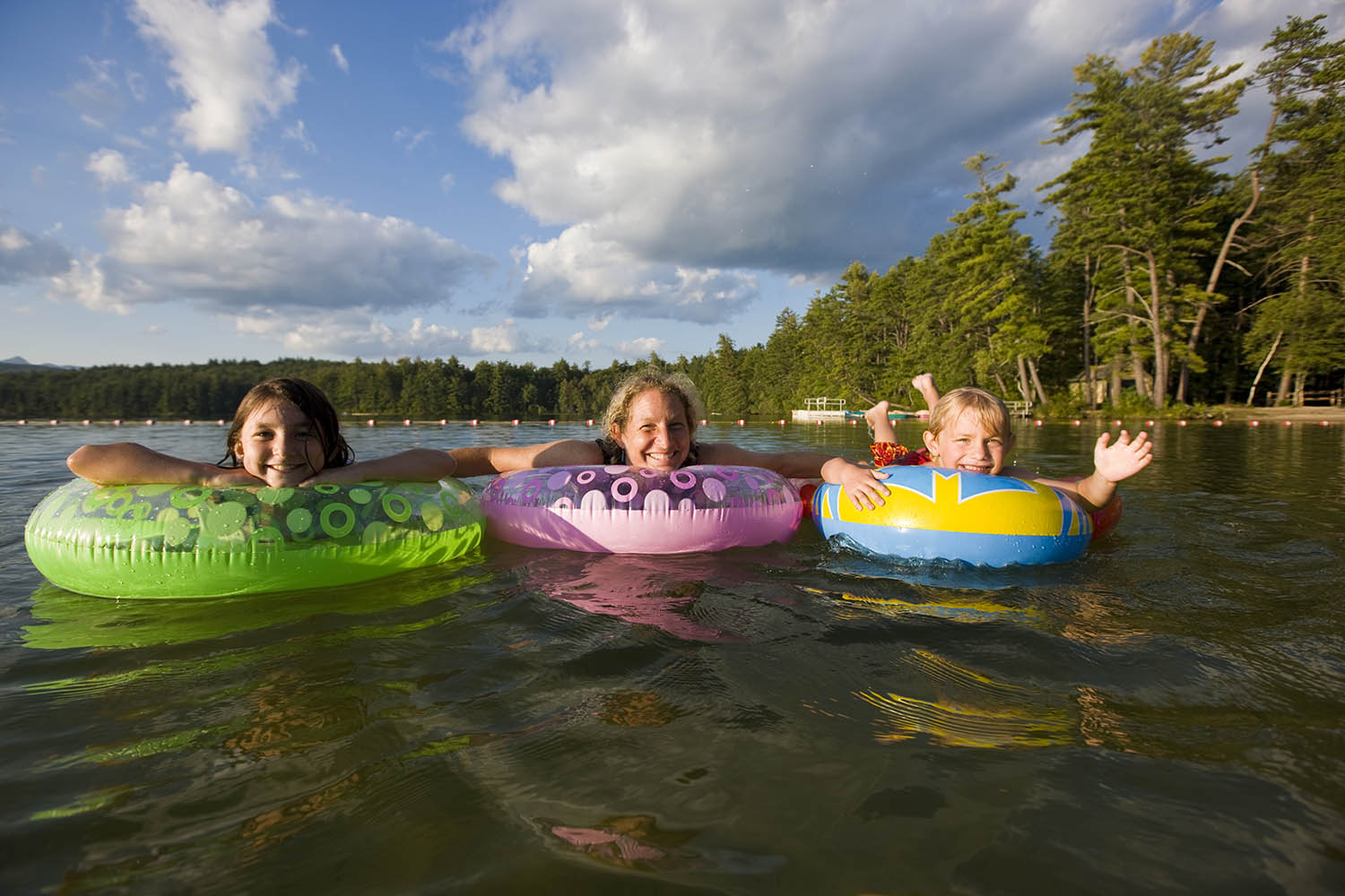 3 kids floating in tubes in the water