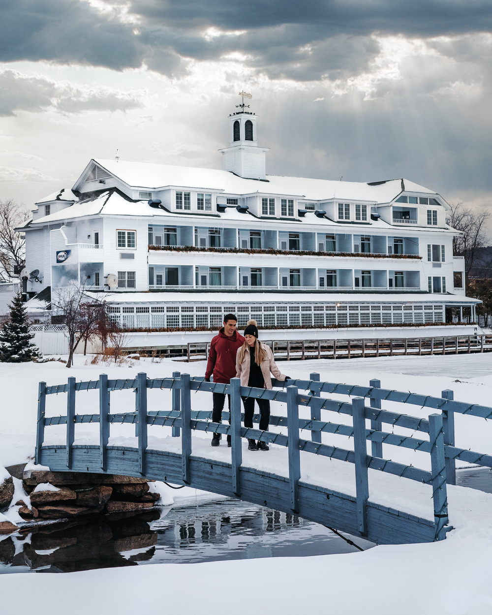 couple in front of an Inn during winter