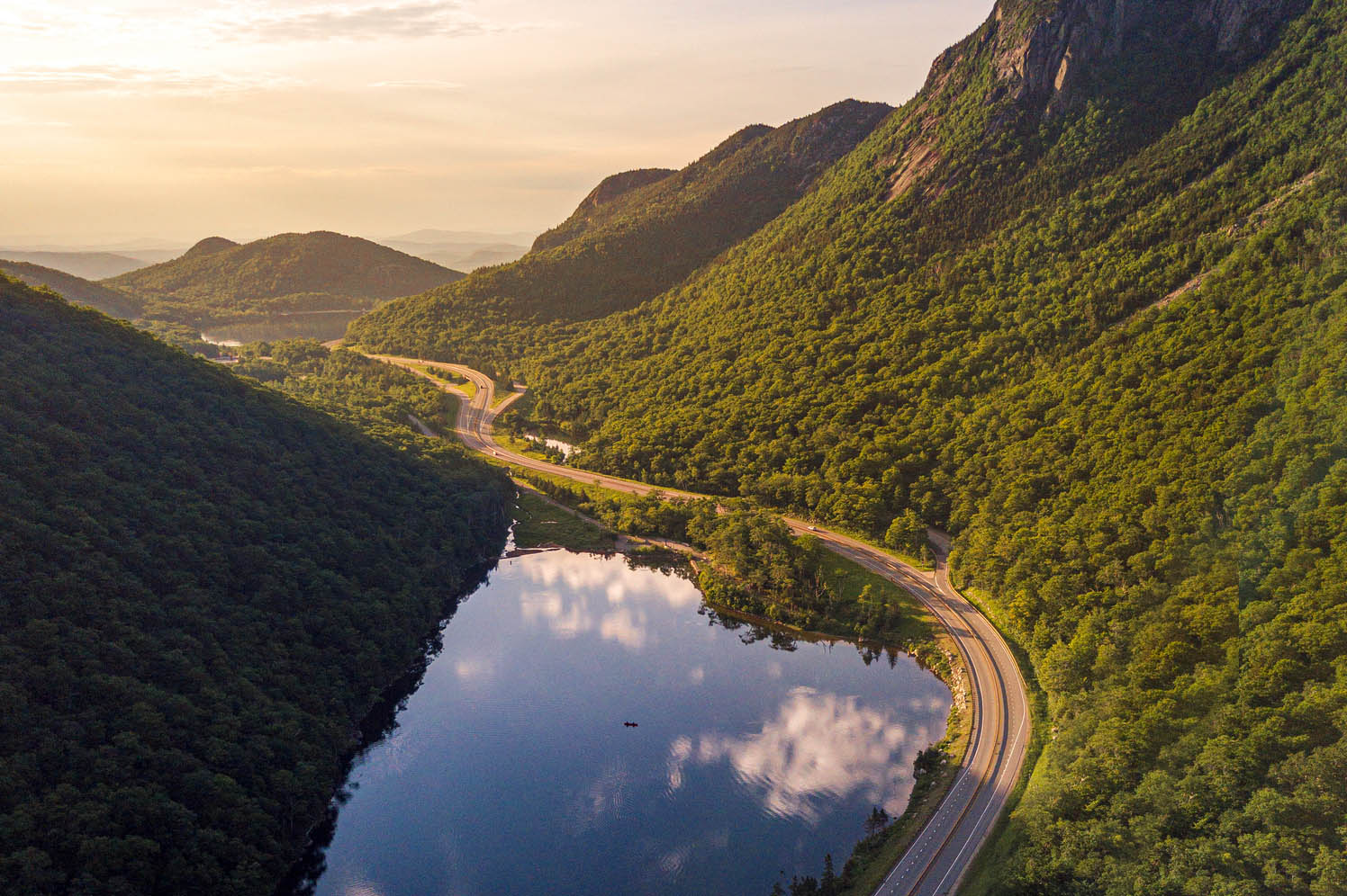 aerial view of road through mountains