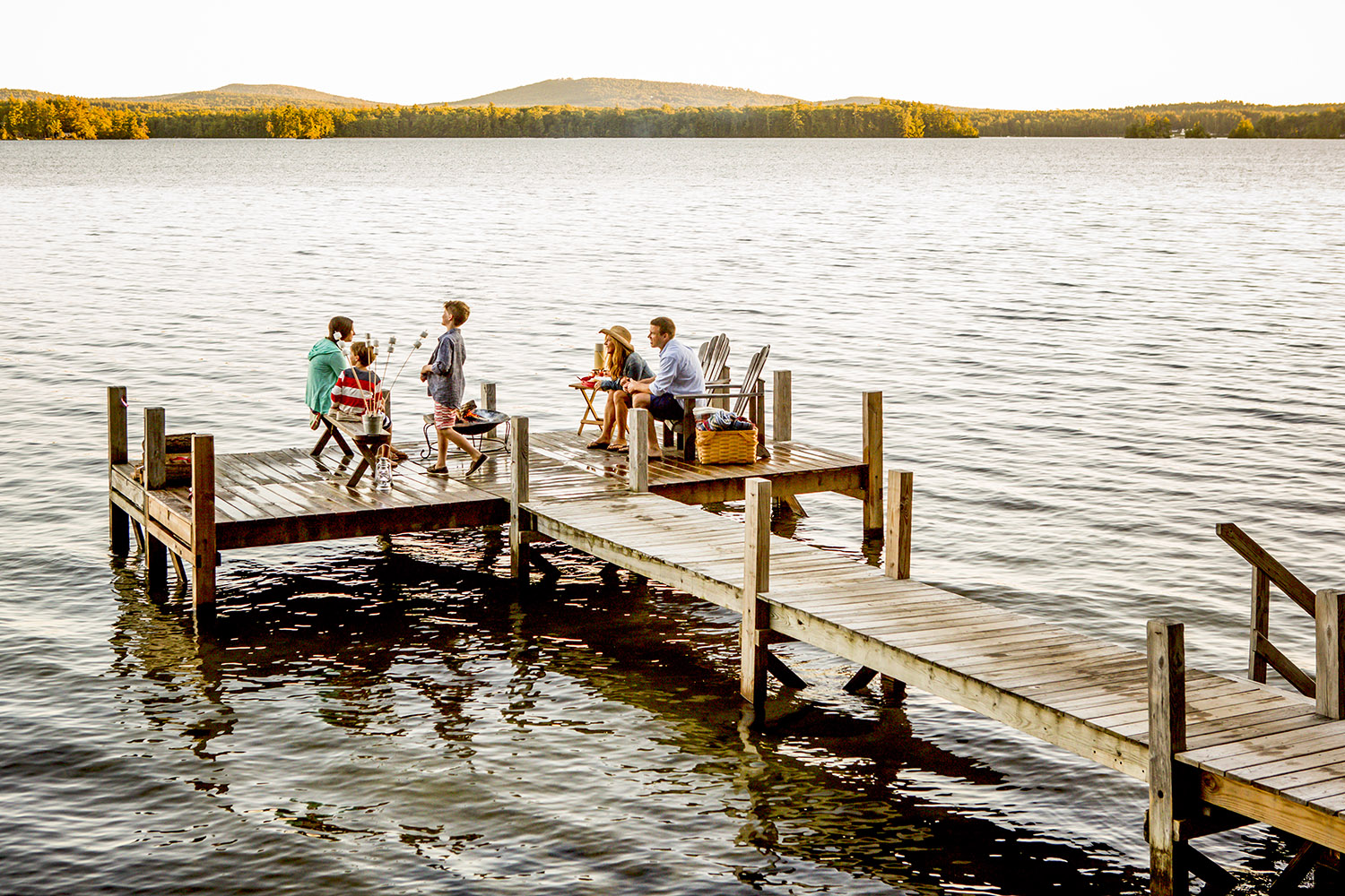 a family playing at the end of a dock