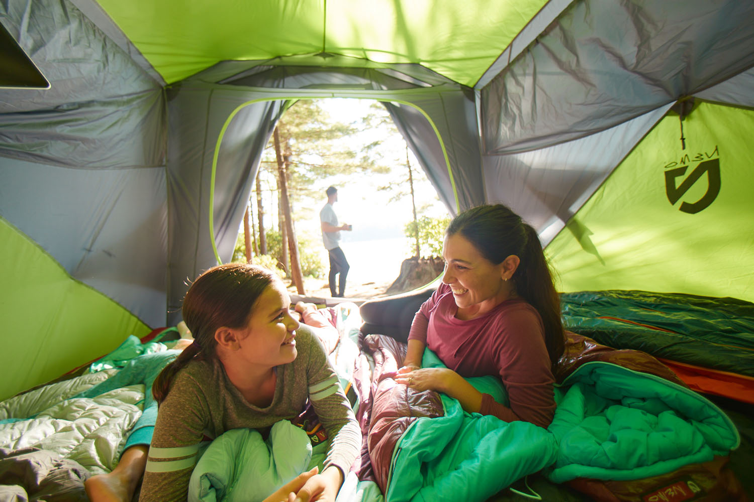 Two people laying in a tent