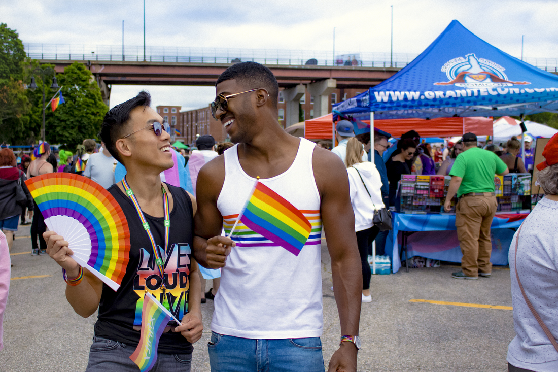 two men with rainbow flags at a festival