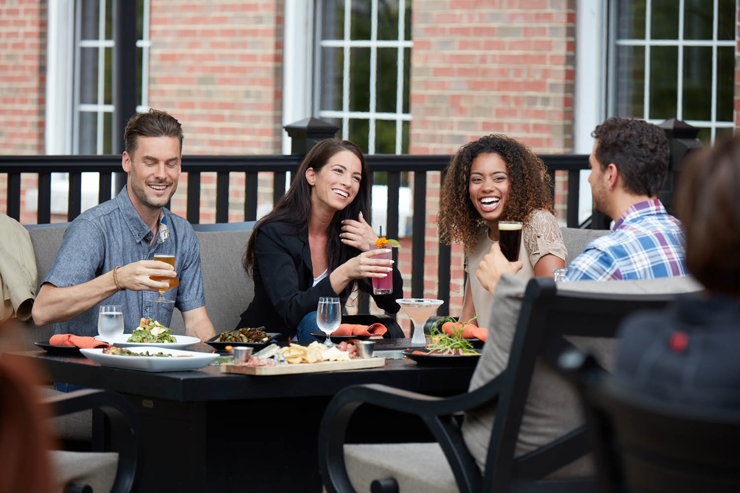 Friends sitting at a table outside eating