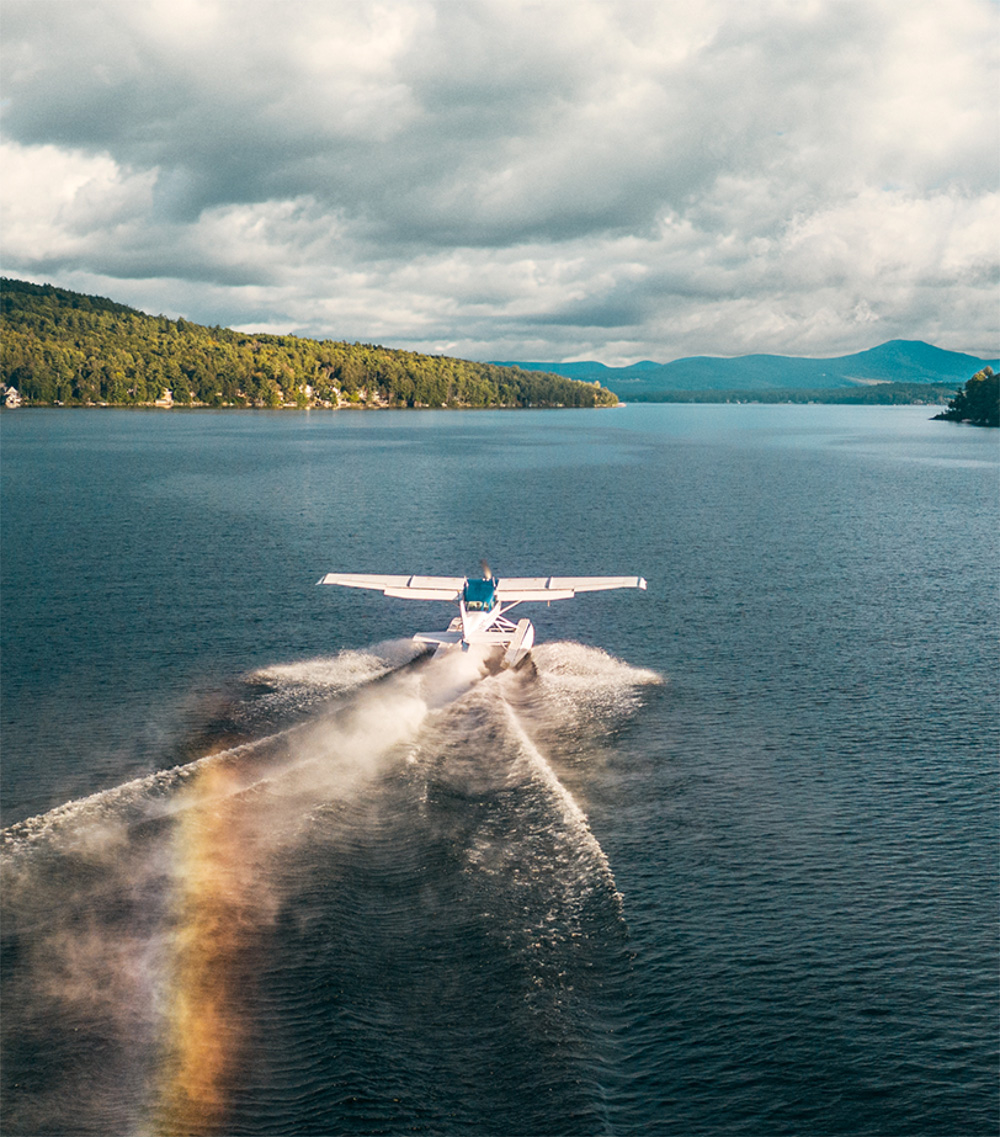 Water plane flying over lake