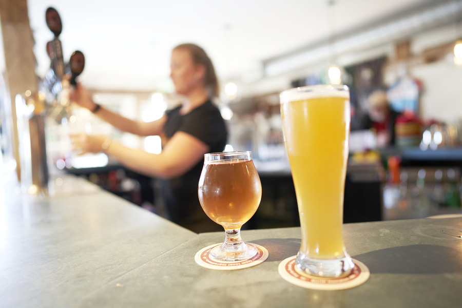 Beer glasses sitting on a bar