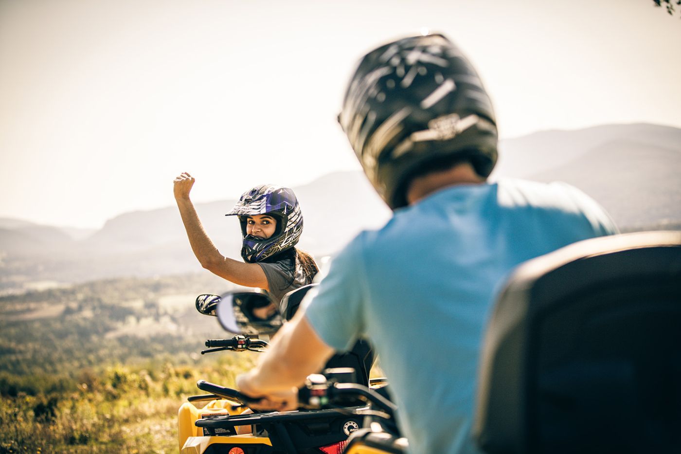 2 people riding ATVs