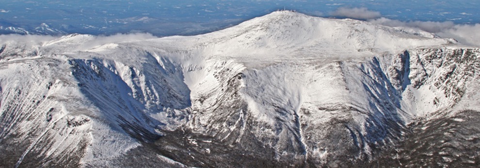 View from the summit of Mount Washington covered in snow on a sunny day