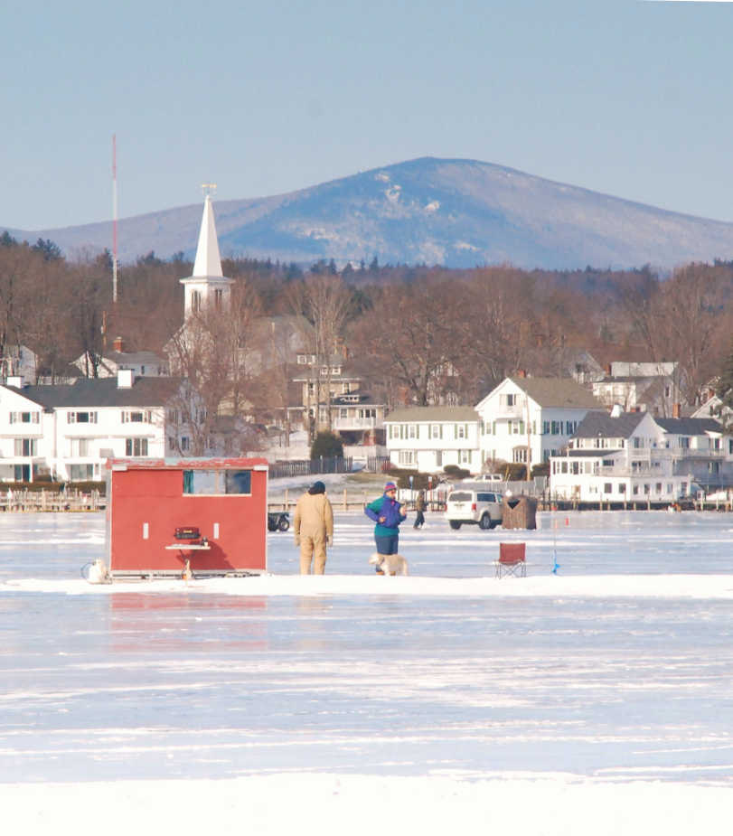 people ice fishing on a pond