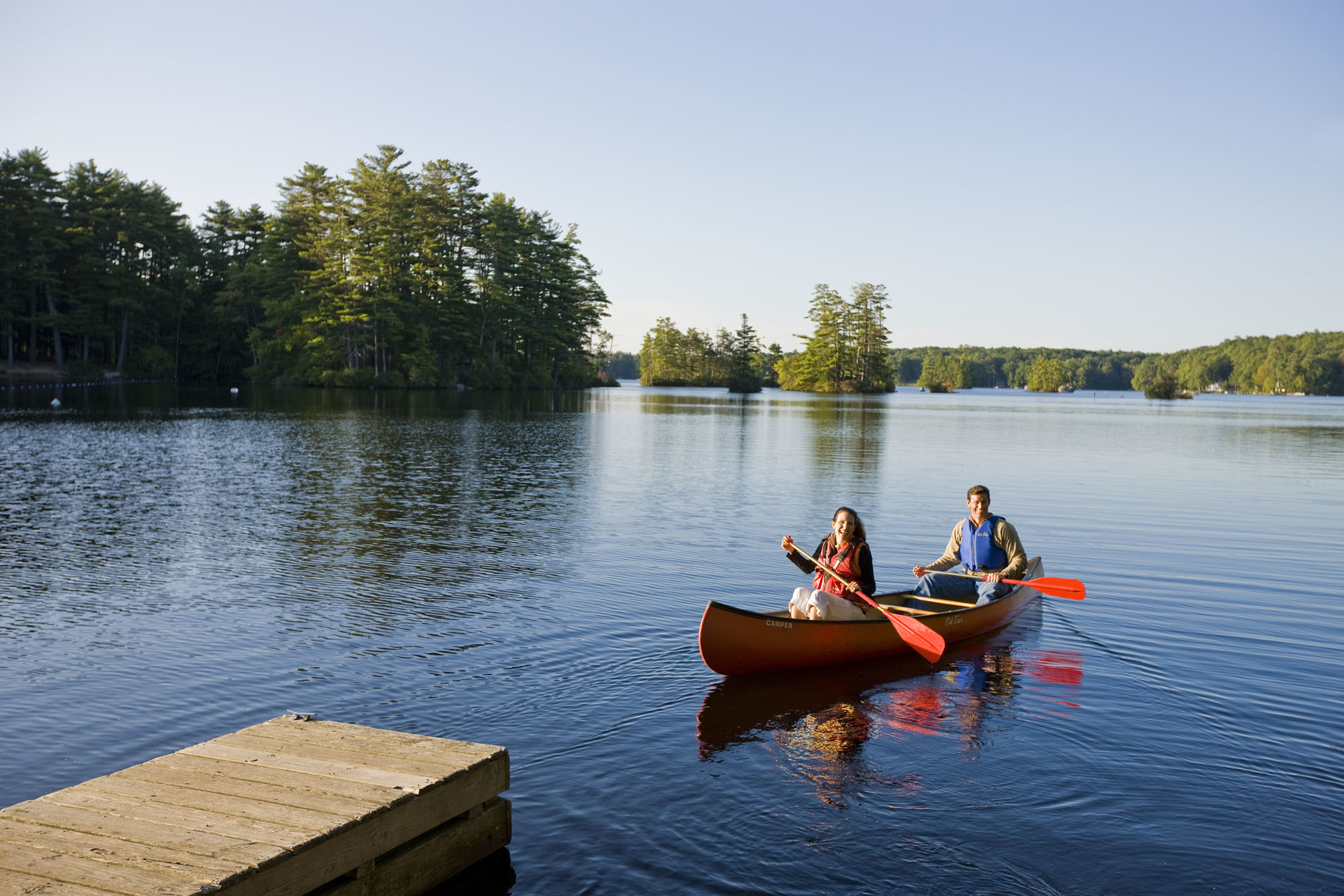 Two people canoeing on a lake