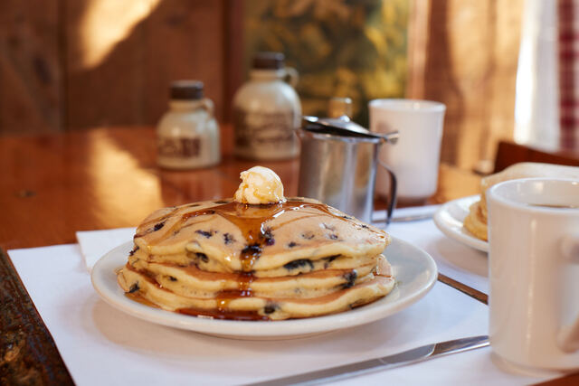 stack of pancakes and maple syrup