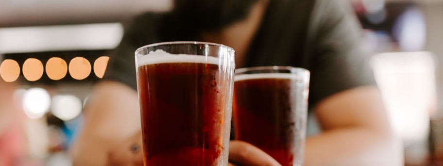 Bartender with beers on bar