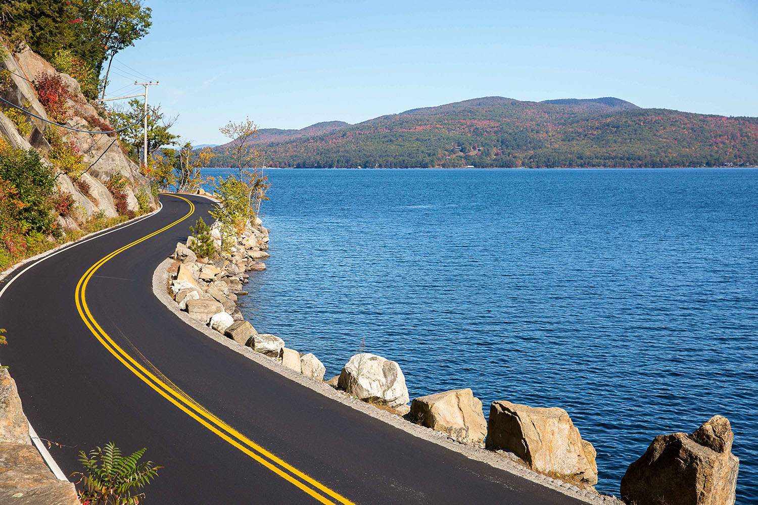 view of a road going around a lake