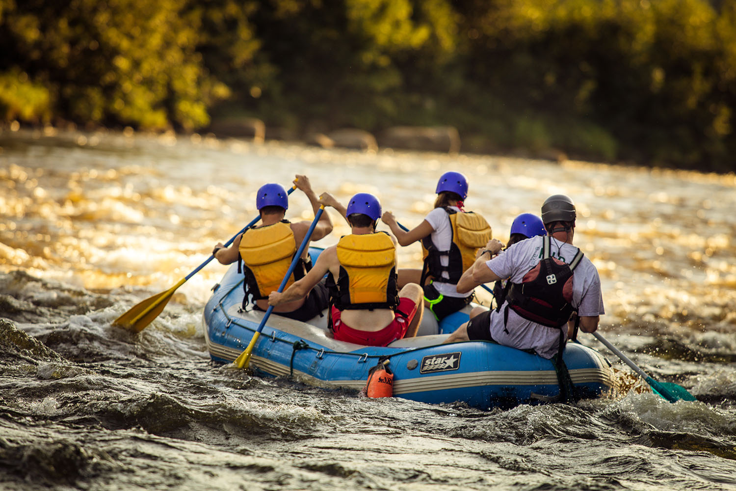 group of friends white water rafting