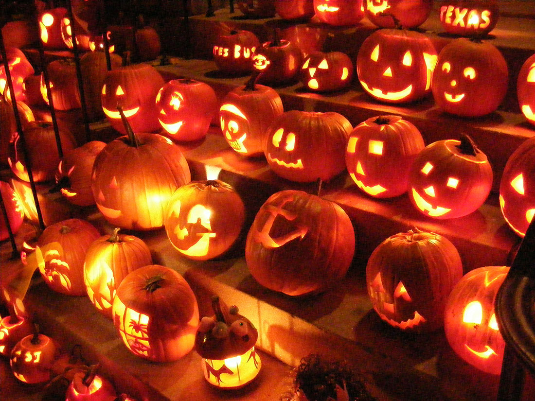 Carved pumpkins lit up at night